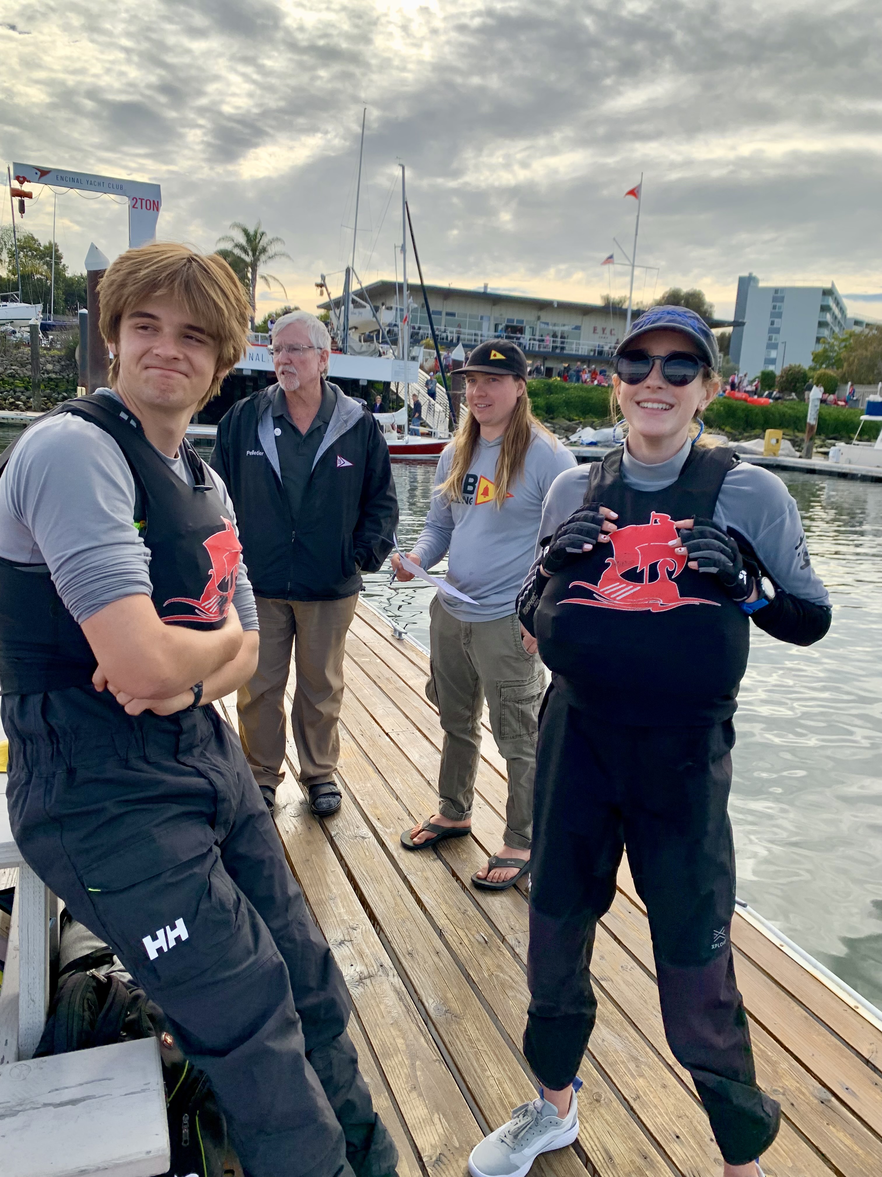 Trevor and Maggie ready to head out sailing at Golden Bear. In the background, Coach Josh and Doc deliberating about filing for redress because of a broken forestay.